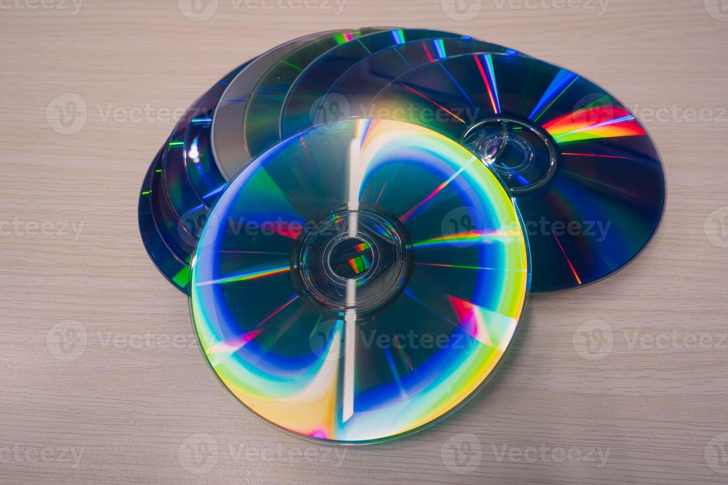 Stack of compact disks on a wooden table. Vcd, blueray photo