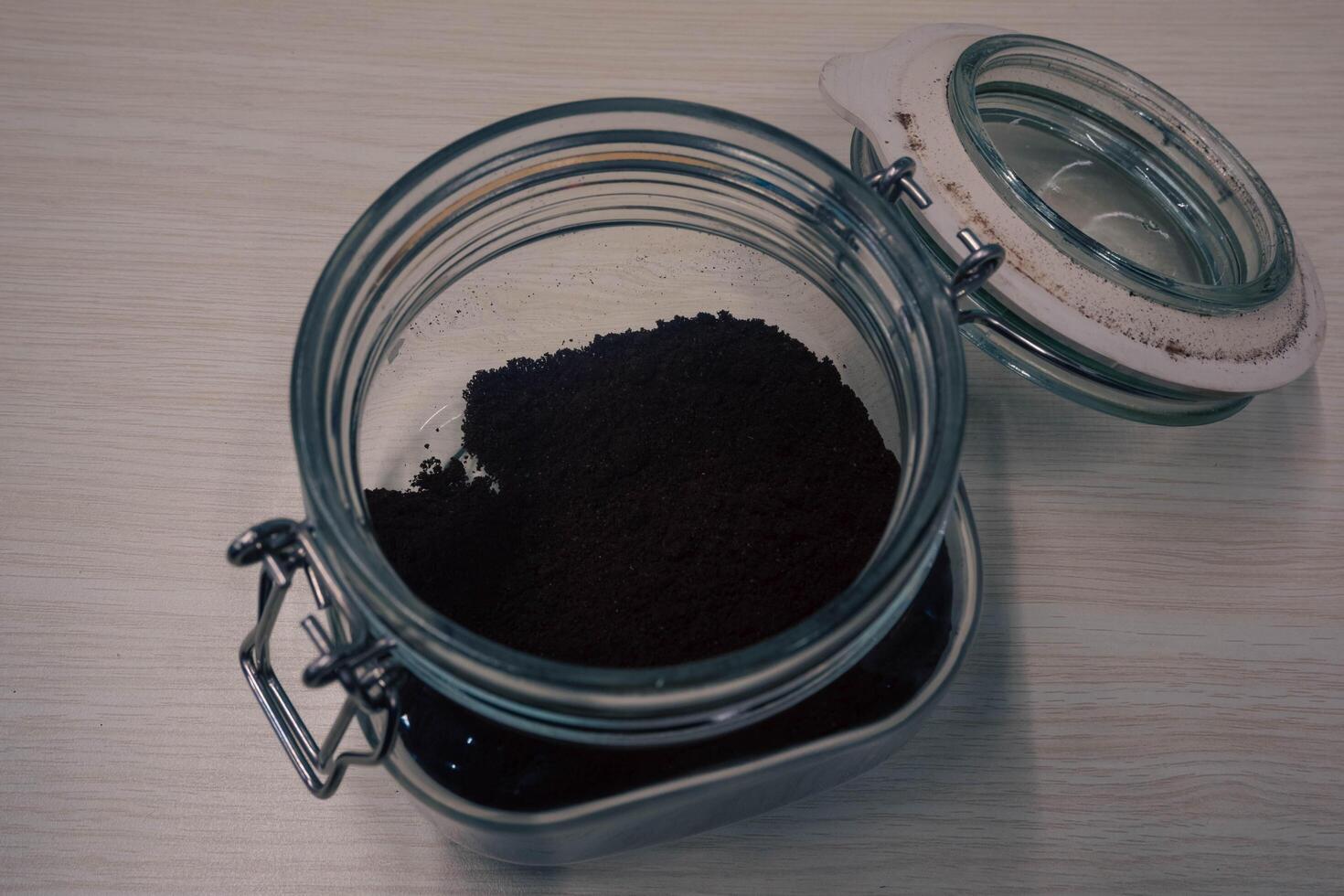 A jar of grind coffee of the Coffea plant and the source for coffee. photo