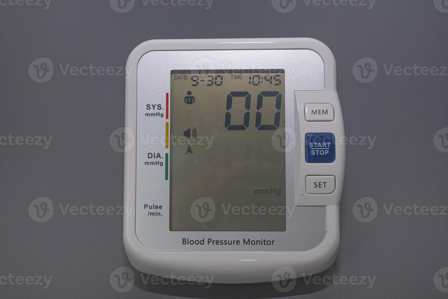 Digital Tensimeter or Blood Pressure Meter with a gray background. Medical device photo