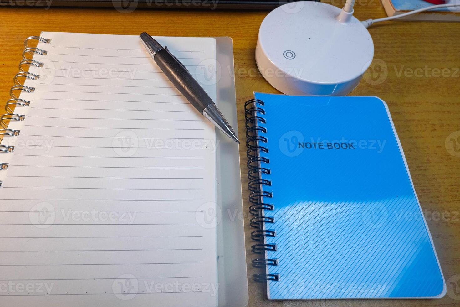 Office table with blank notebook, pen and laptop. office desk top view with blank notebook photo