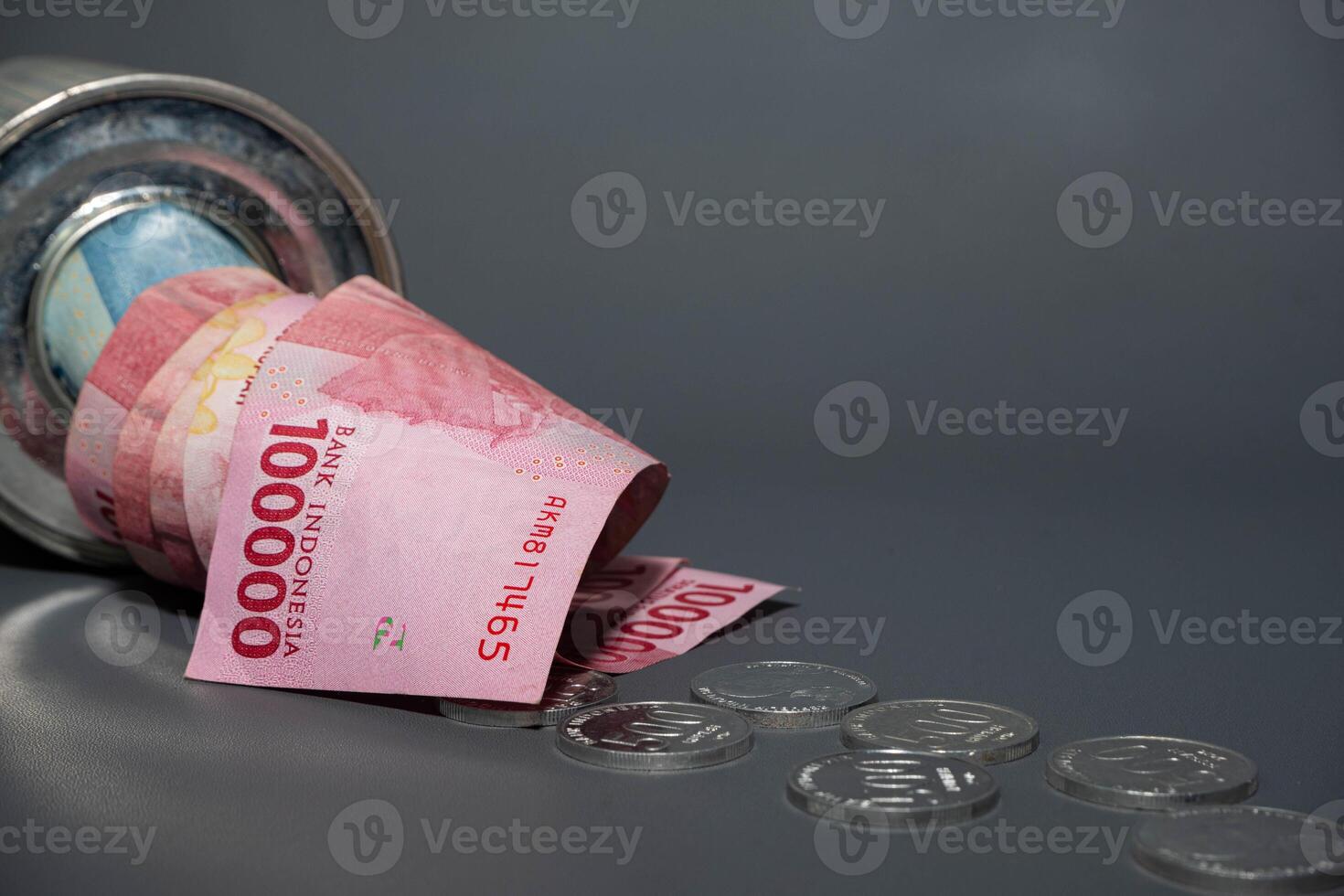 Save Indonesian rupiah in a savings can. Collecting money. Business, finance, savings and banking concept. photo