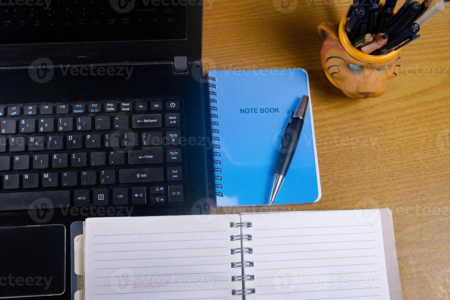 Office table with blank notebook, pen and laptop. office desk top view with blank notebook photo