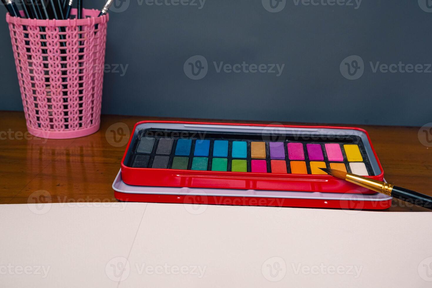 Blank sketchbook, color palette and a set brush, top view photo