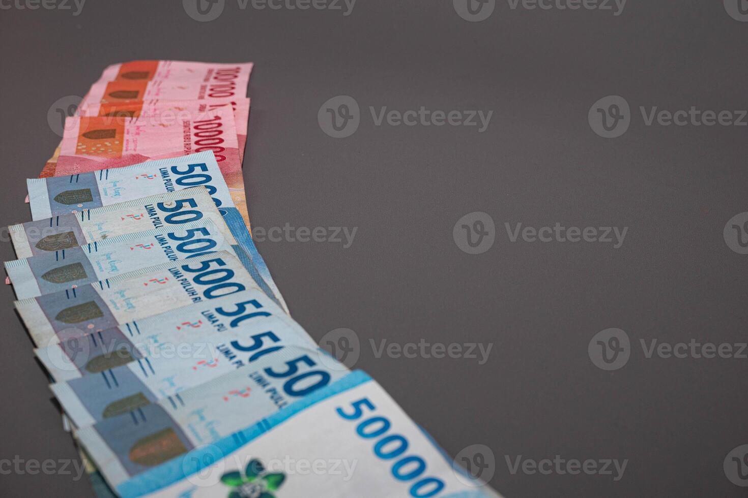 Indonesia banknote The rupiah is the official currency of Indonesia. In grey background. With copy space photo