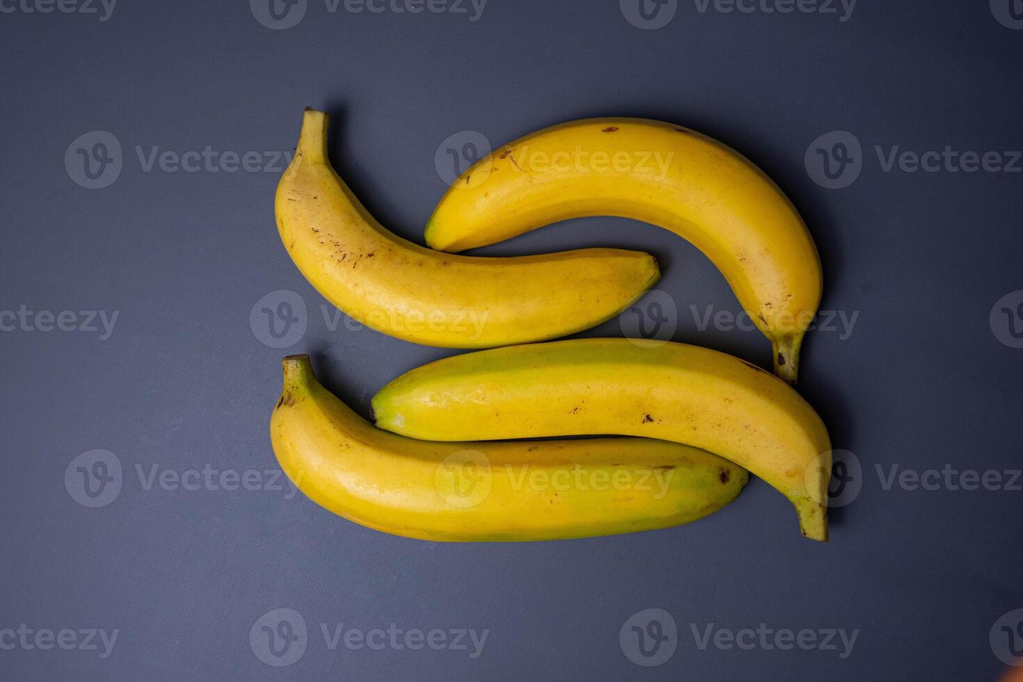 Delicious yellow fruit. Banana fruit isolated on gray background. Bunch of bananas. photo