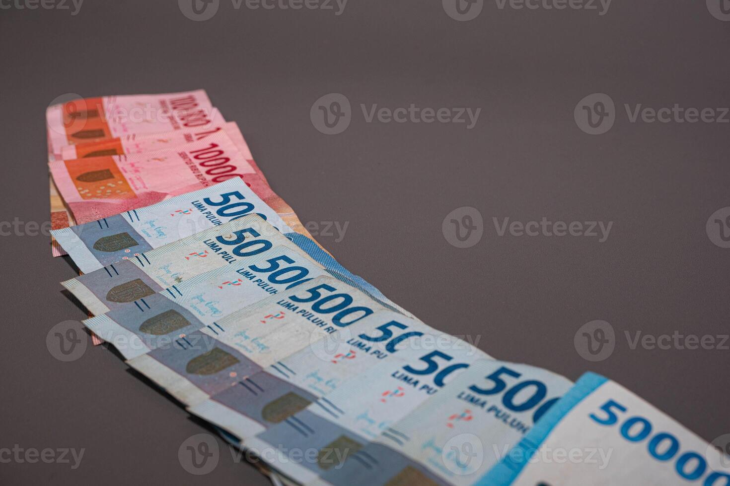 Indonesia banknote The rupiah is the official currency of Indonesia. In grey background. With copy space photo