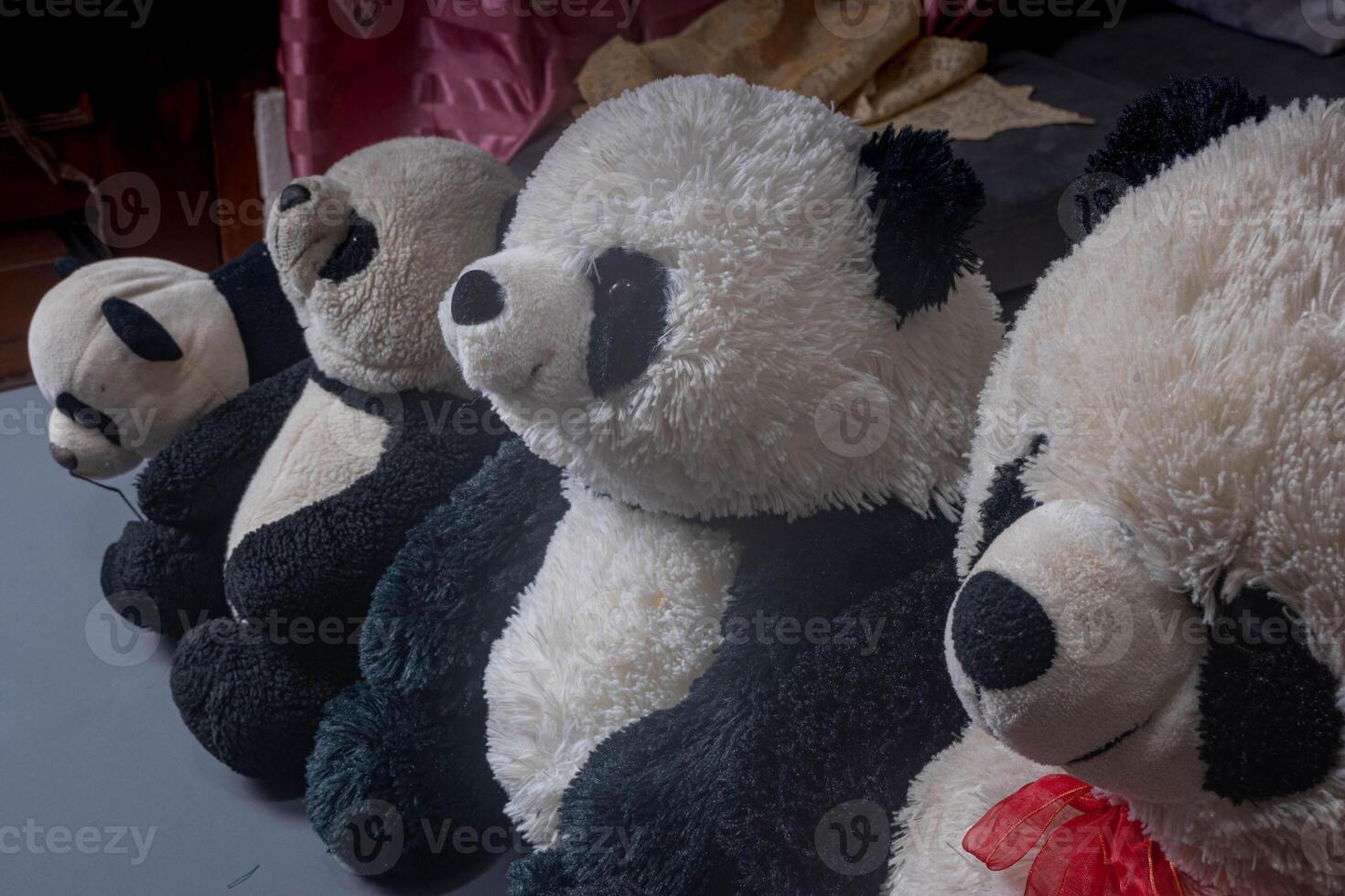 Black and white stuffed panda bears in a row. Soft and adorable stuffed toy. photo