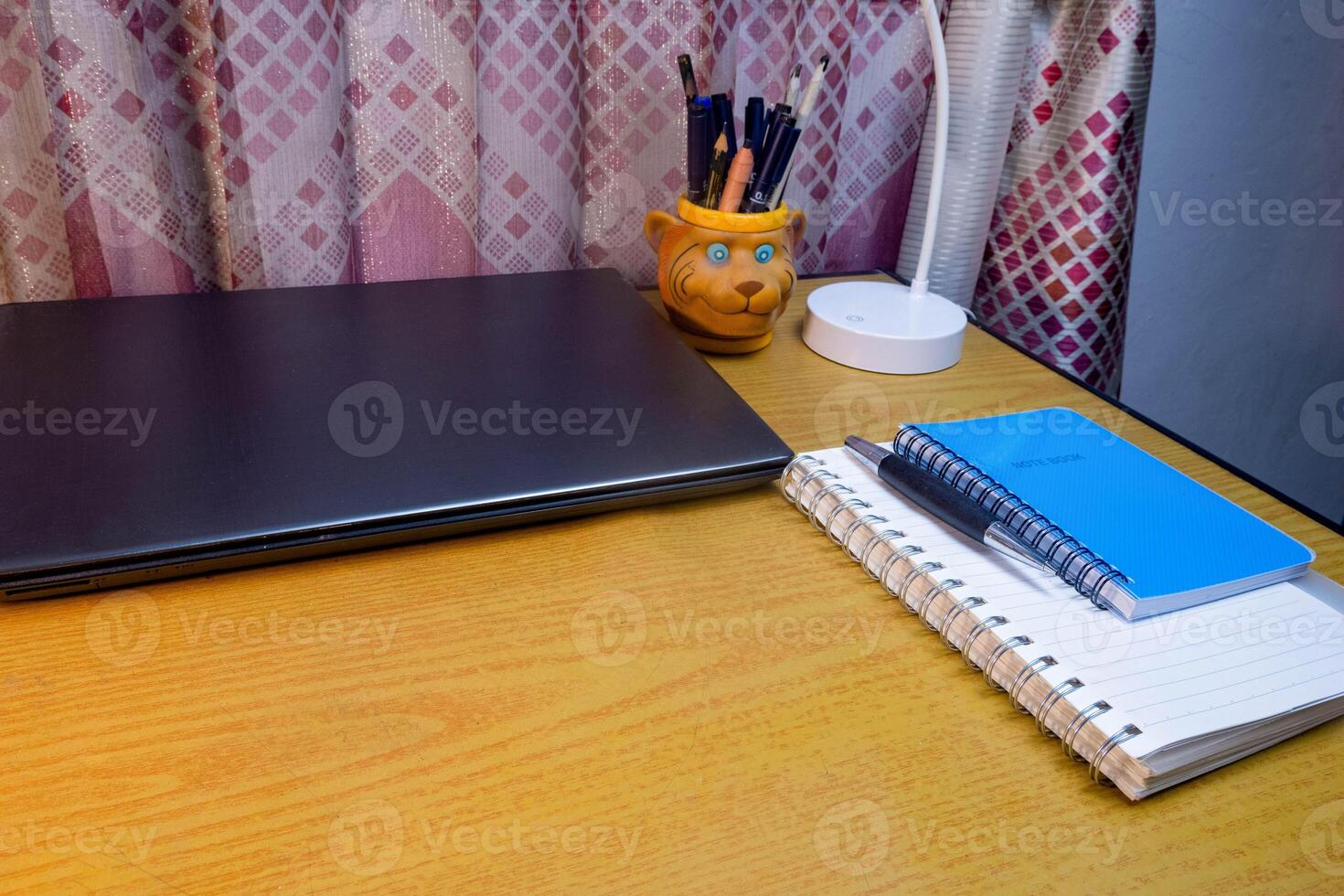 Office table with blank notebook, pen and laptop. office desk top view with blank notebook photo