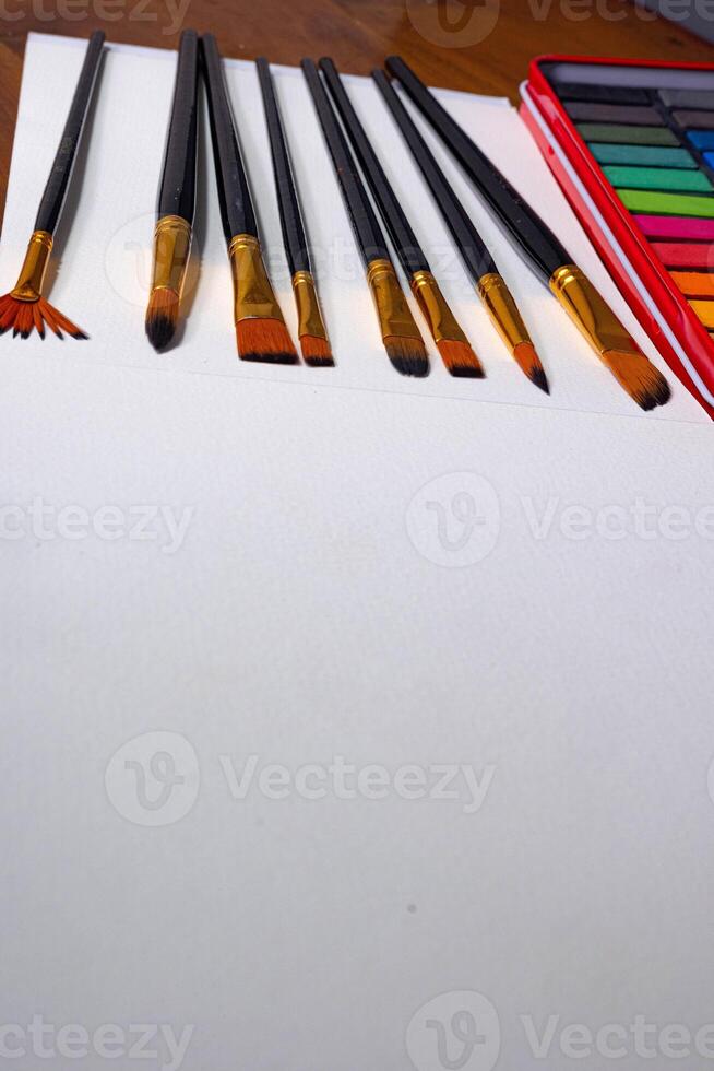 Blank sketchbook and a set brush, top view photo