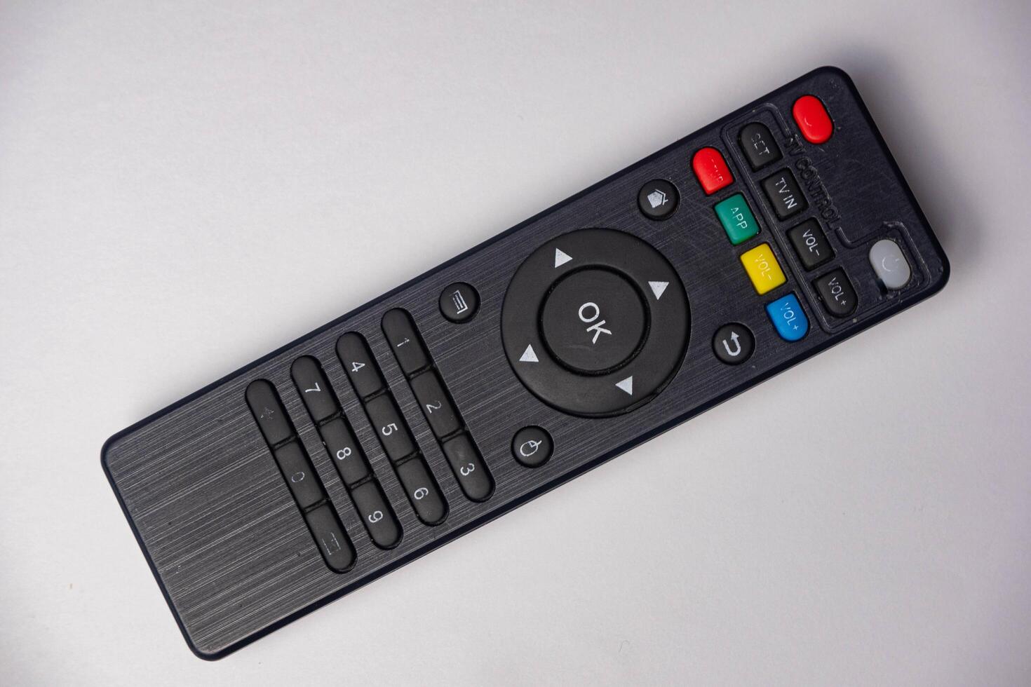Black remote control for tv on a white background. photo