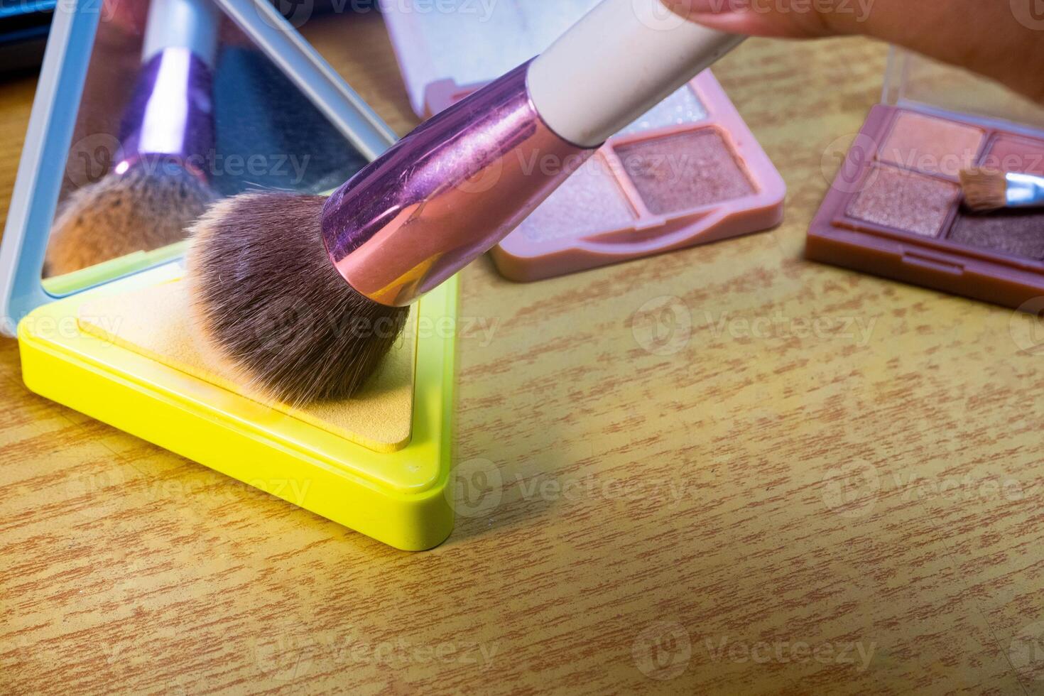Make up tools. Loose powder case with mirror and makeup brushes. Makeup brush on foundation. Concept of cosmetics, cosmetology. photo