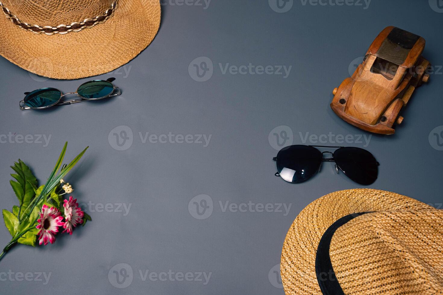 Two straw hats with two sunglasses on a gray background, summer beach fashion concept. Vacation, tourism photo