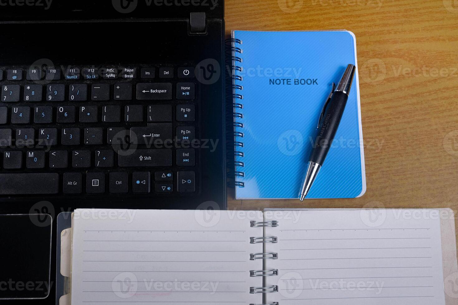 Office table with blank notebook, pen and laptop. office desk top view with blank notebook photo