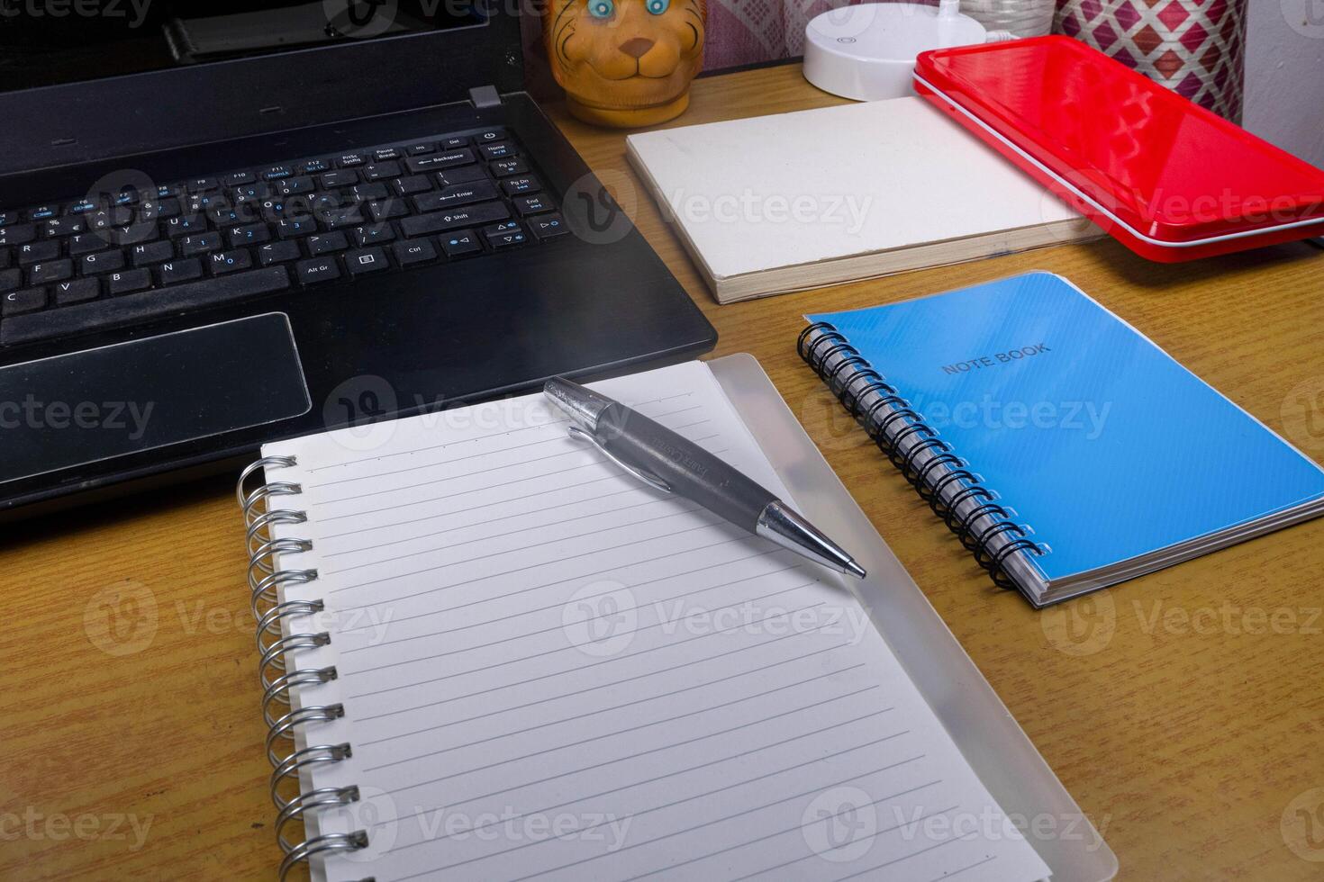 Office table with blank notebook, pen and laptop. office desk top view with blank notebook photo