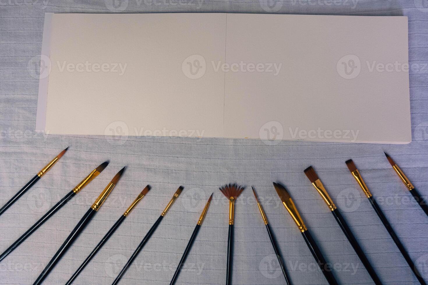Blank sketchbook and a set brush, top view photo