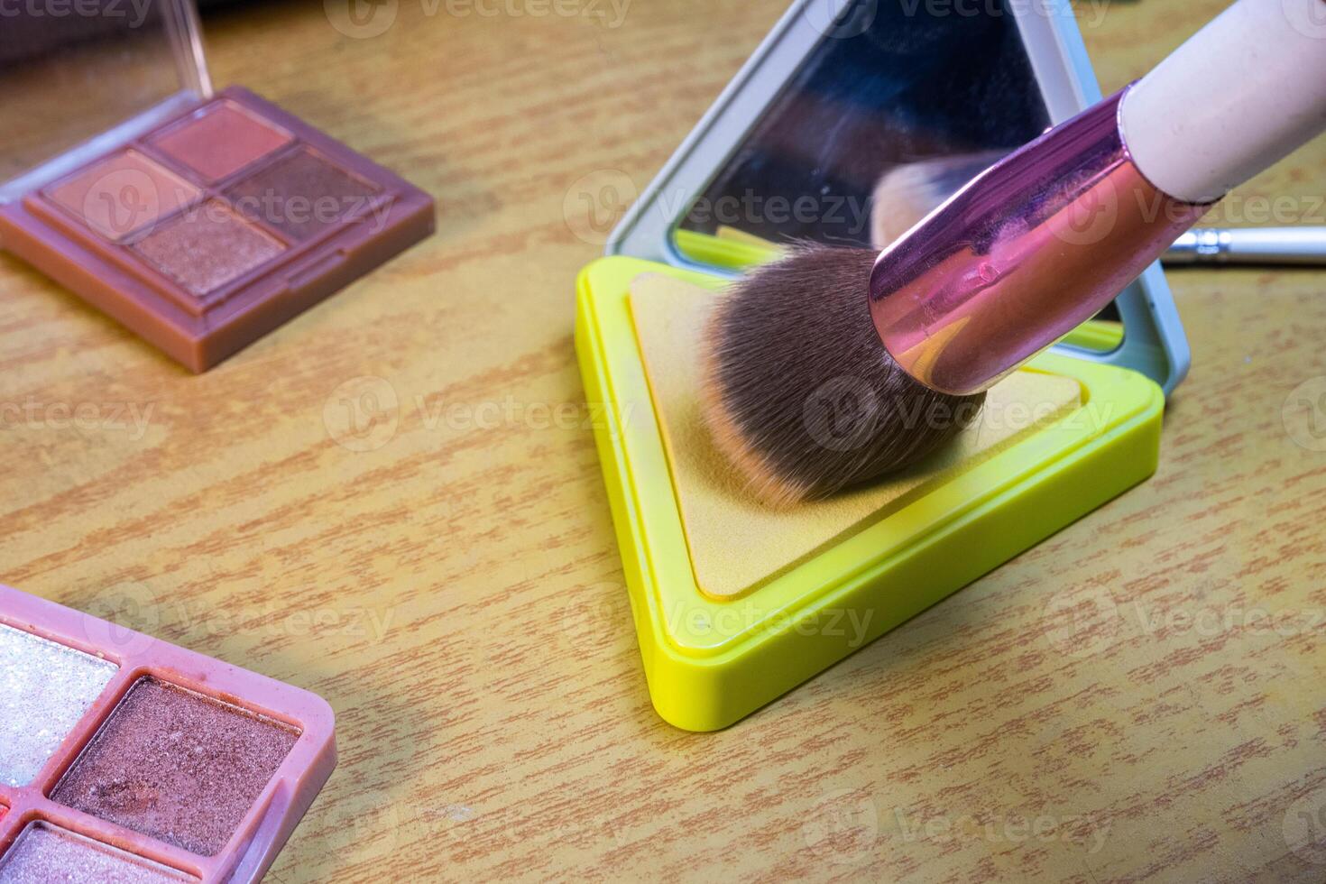 Make up tools. Loose powder case with mirror and makeup brushes. Makeup brush on foundation. Concept of cosmetics, cosmetology. photo