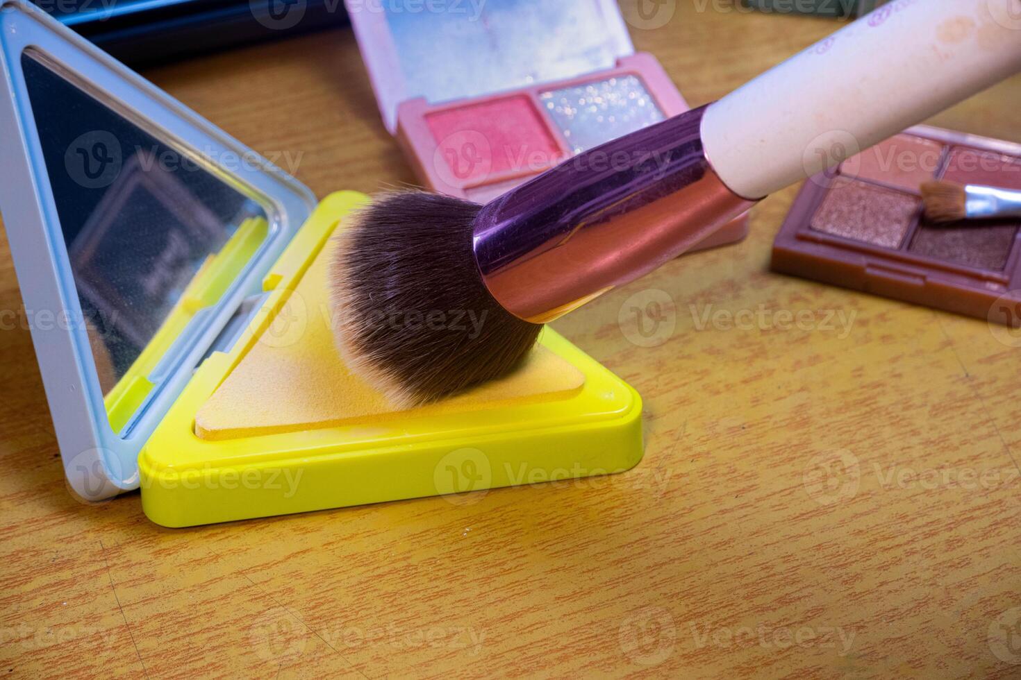 Make up tools. Loose powder case with mirror and makeup brushes. Makeup brush on foundation. Concept of cosmetics, cosmetology. photo