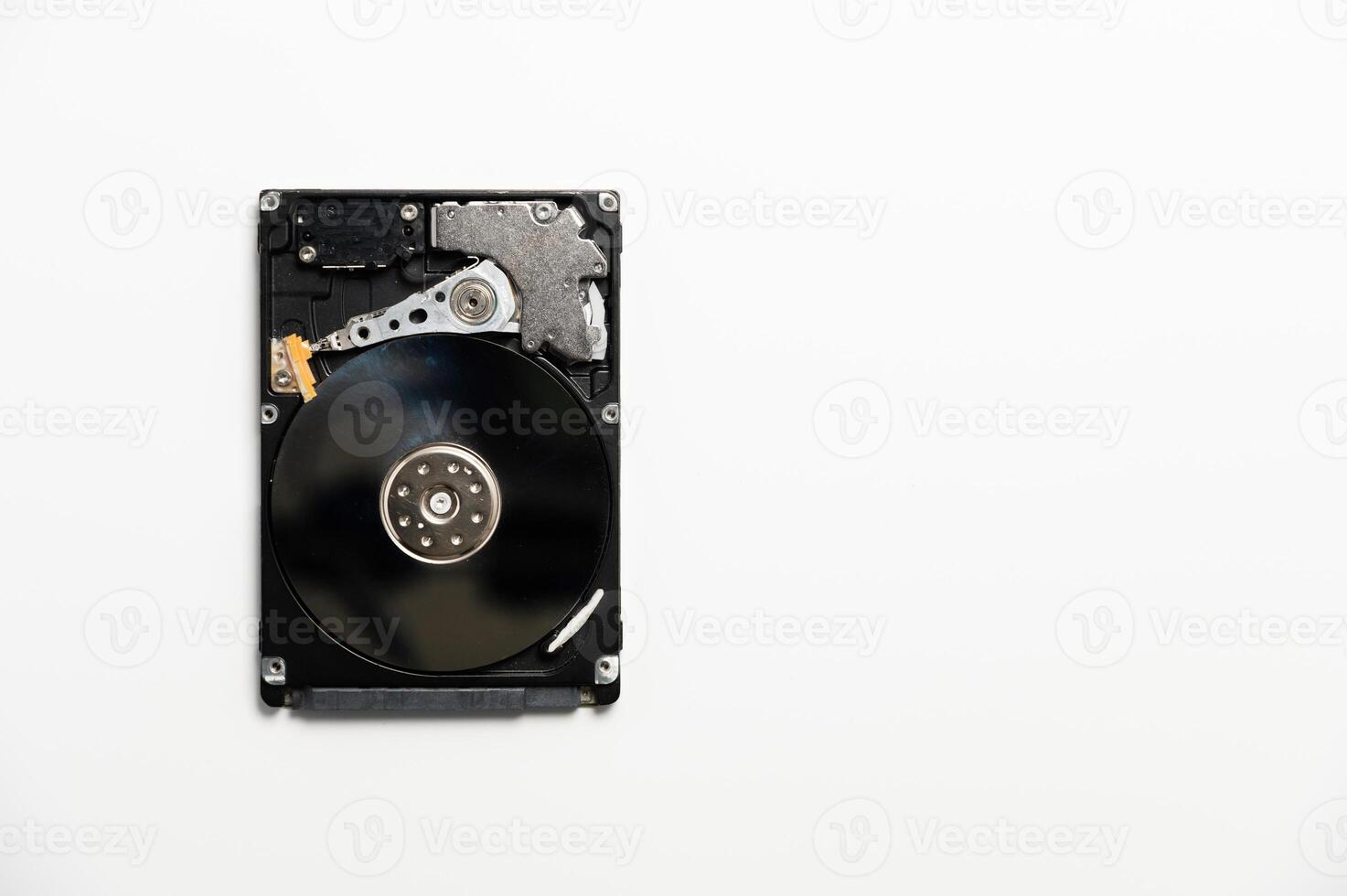 White background on which lies a sleek hard drive, combining modernity and simplicity in a technologically minimalist aesthetic. photo