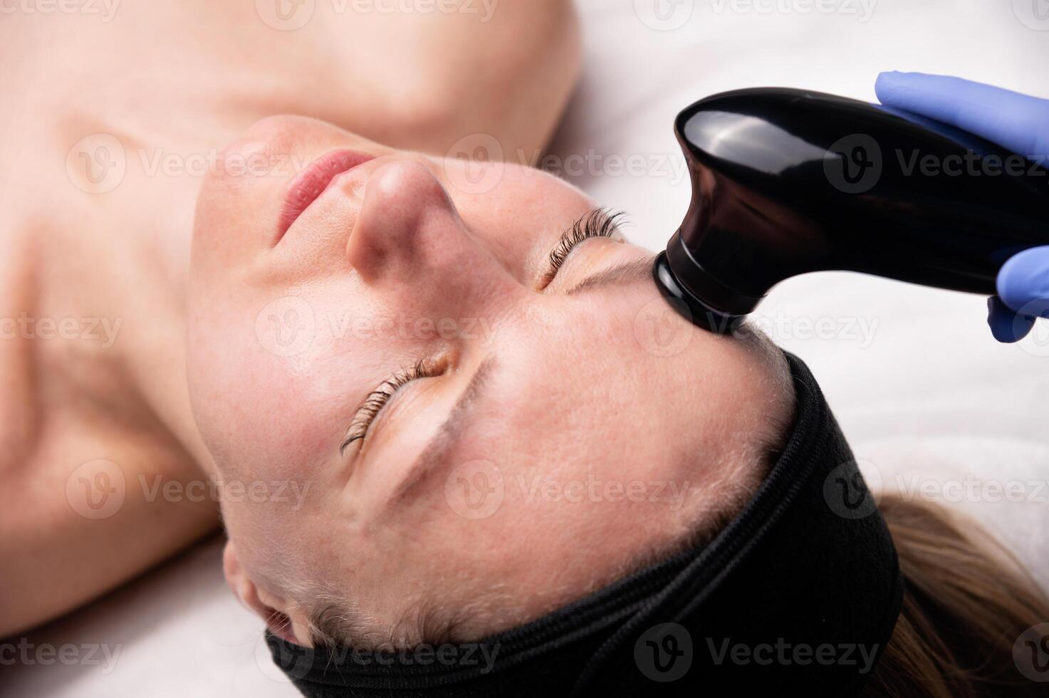 Face lifting. Hardware rejuvenating procedure, vacuum cleaning. Cosmetic procedure for the face, close-up photo