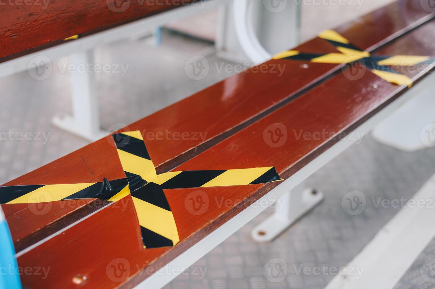 The marking on empty wooden chair without nobody sitting on it. Keep spaced between each chairs make separate for social distancing to avoid spreading of Covid-19. Social distance concept. photo
