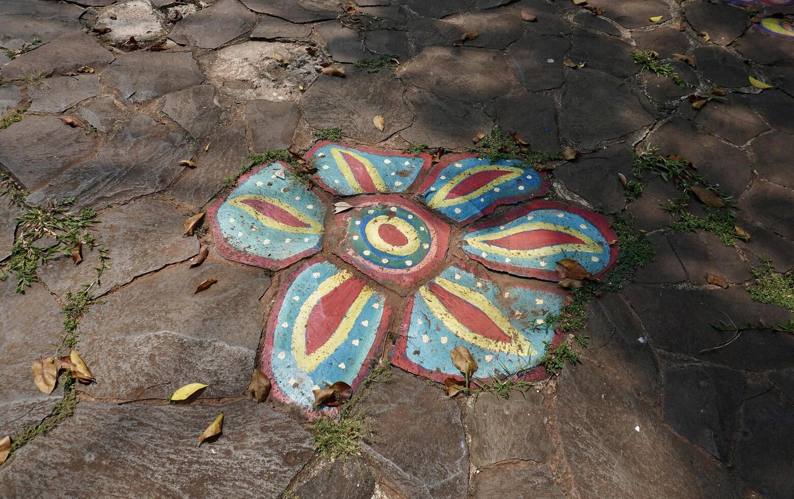 Stone rock outdoor ground flooring with abstract flower petal painting on the surface isolated on horizontal ratio background. photo