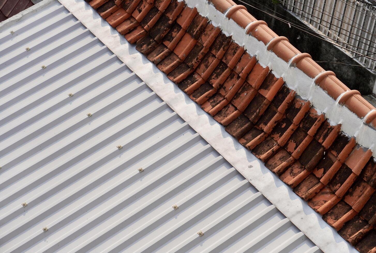 Gray metal and red brown clay building roof texture isolated on horizontal ratio background. photo