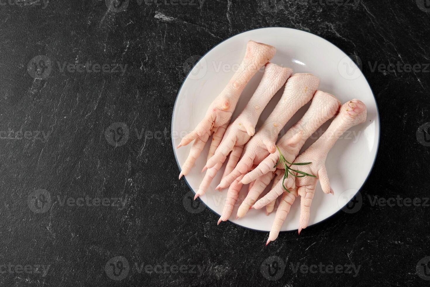 Top View Chicken Feet or Ceker Ayam on White Plate photo