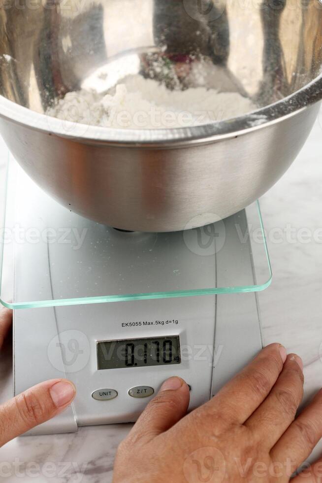 Female Hand Preparing Baking Scale and Flour photo