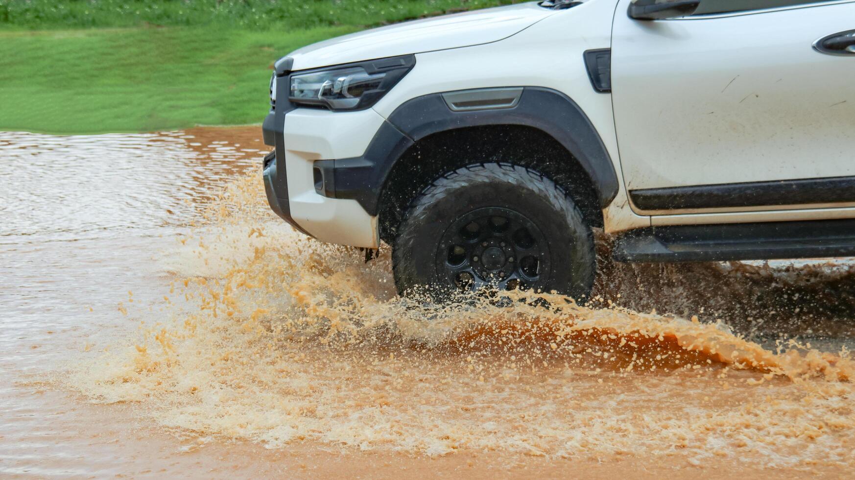 Floodwater splashing violently caused by a vehicle which is driven through. photo