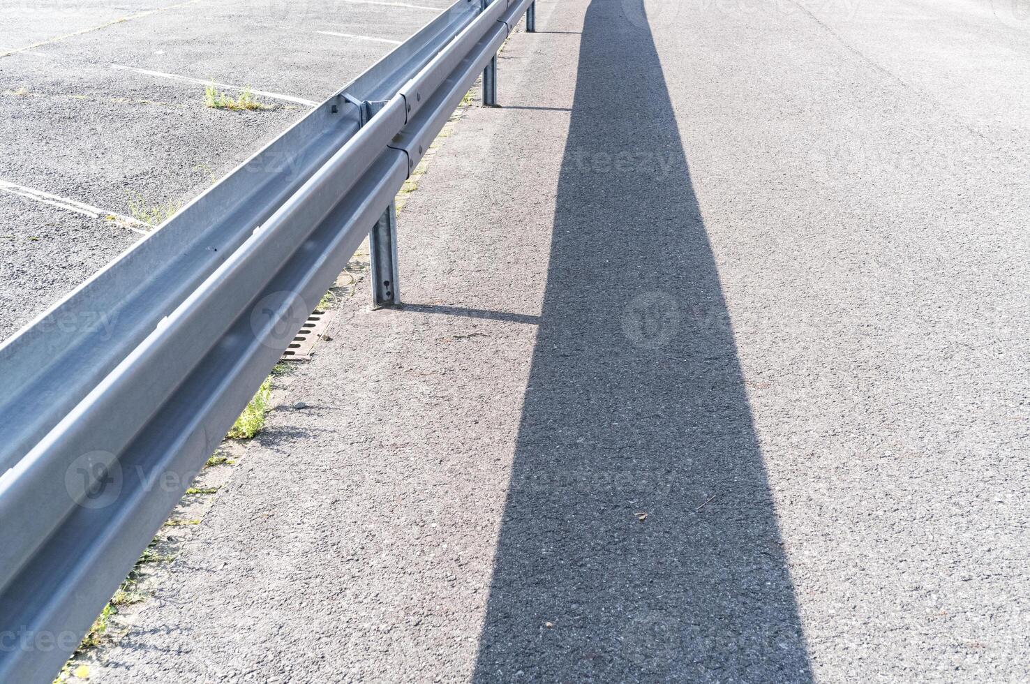 Guard rails on the road in the sun photo