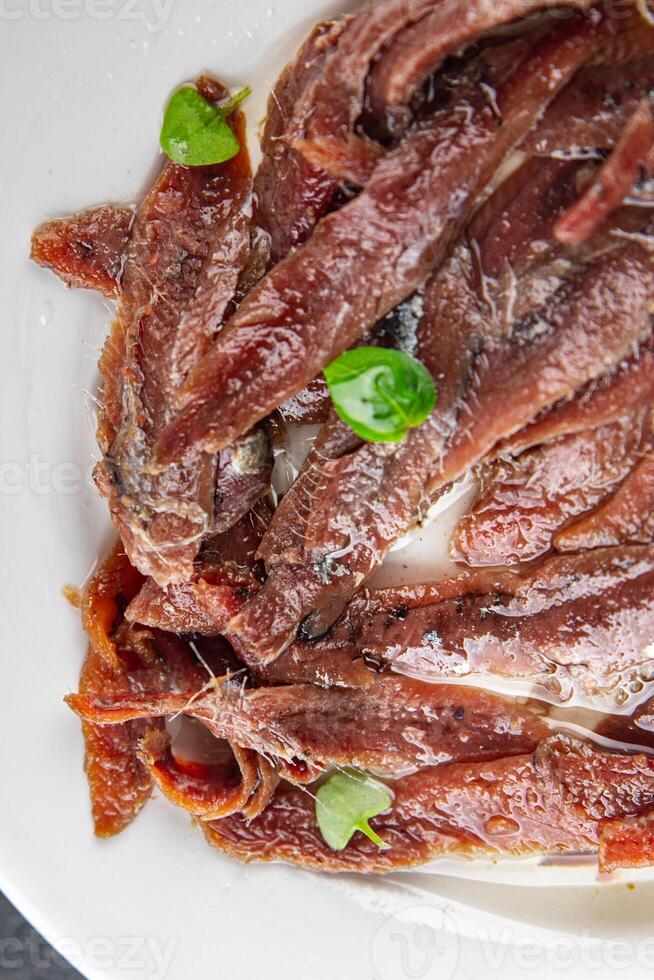 anchovies in a plate on the table canned fish in oil fresh and tasty seafood meal food snack on the table copy space food background rustic photo