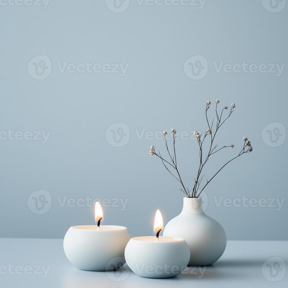 Minimalist still life with round candles and a simple vase with delicate branches on a light background photo