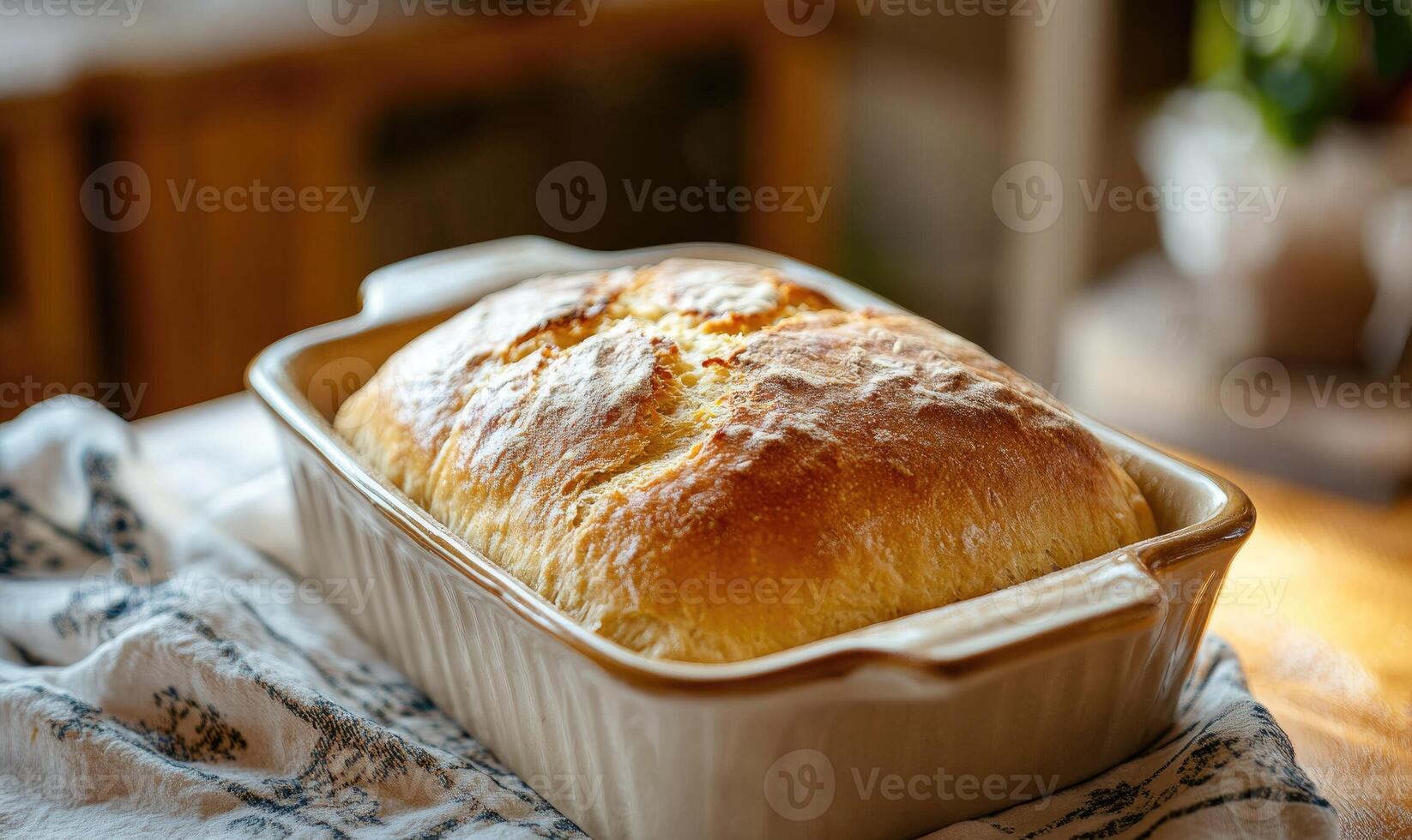 Golden loaf of bread in a ceramic dish photo