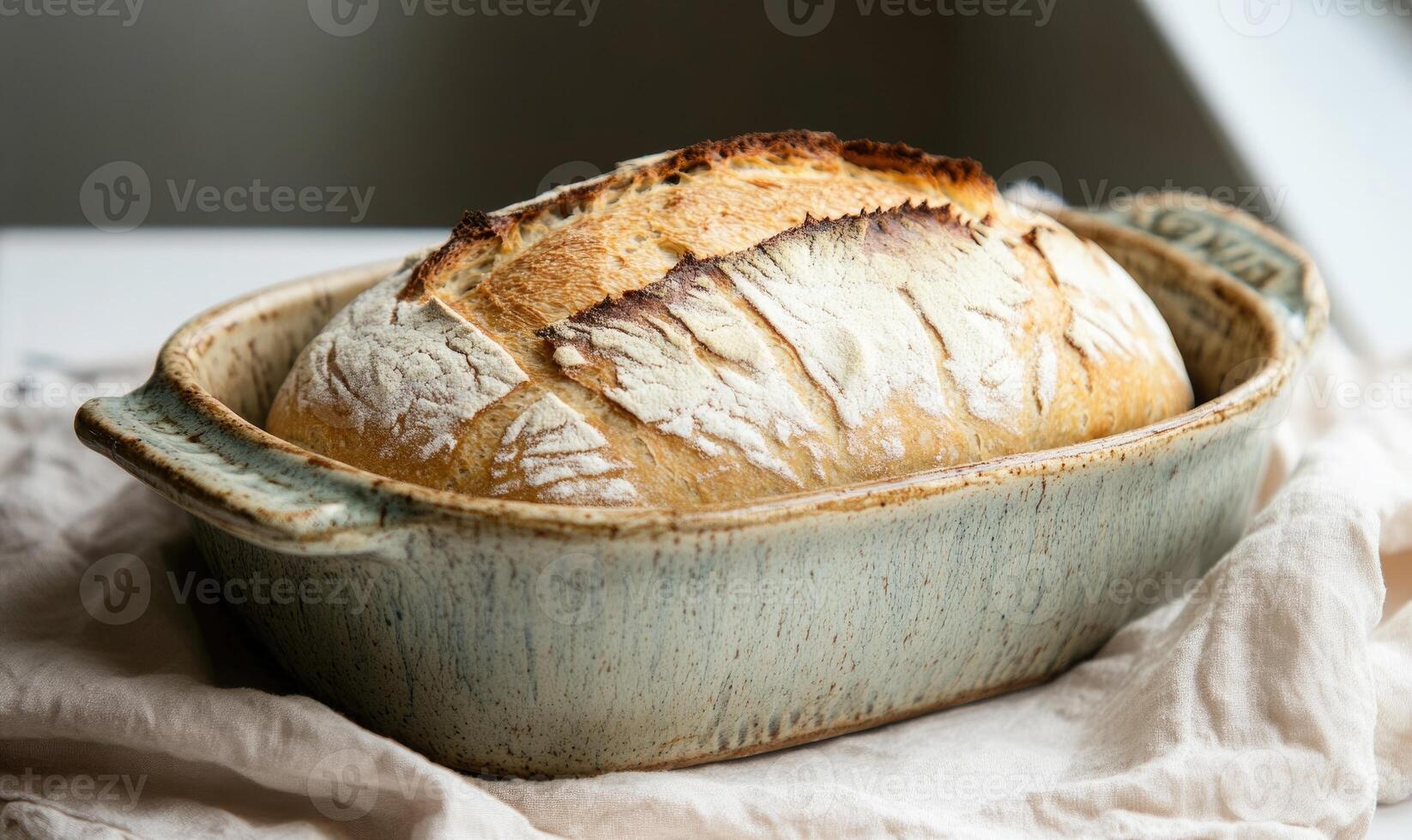 Loaf of bread in a ceramic dish, farmhouse feel photo