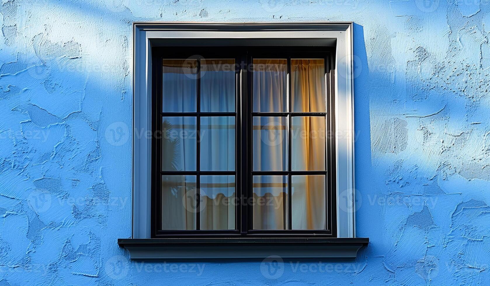 A window with a curtain is shown in a blue building. The sunlight is shining through the window, creating a warm and inviting atmosphere photo