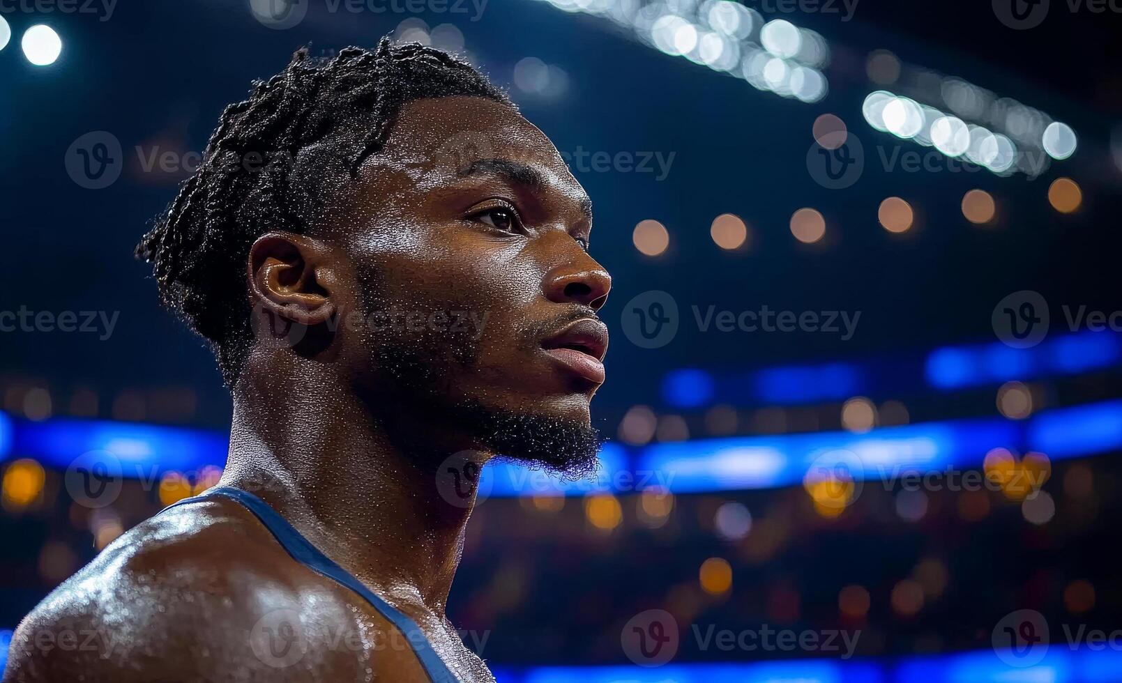 A man with a beard and dreadlocks is sweating in a boxing ring. He looks tired and exhausted photo