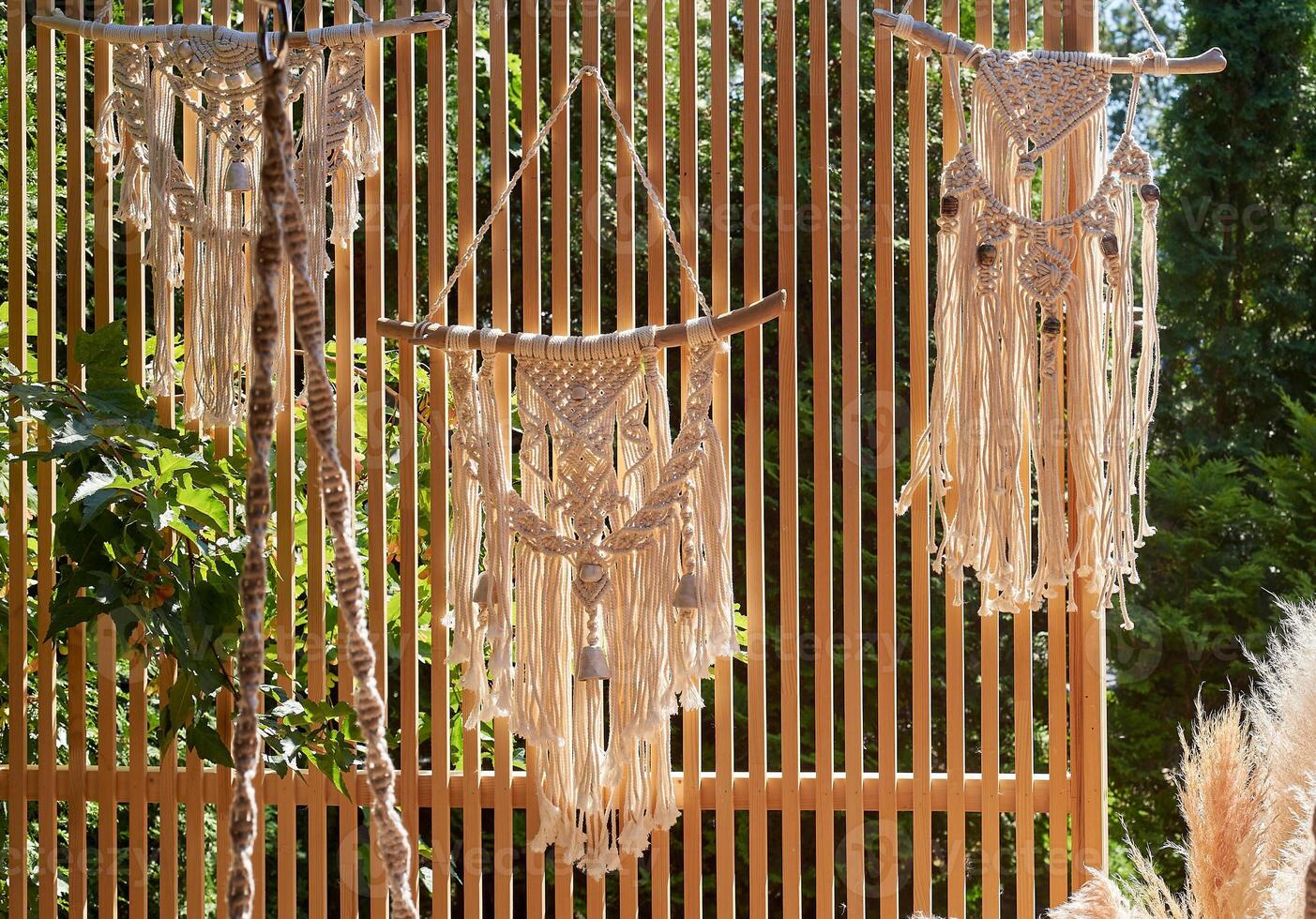 Wedding decoration. Floristics. Dream catcher. Macram on the background of a wooden partition photo