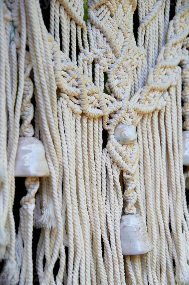 Macram weaving. Light thread with large beads. Near. Boho style photo