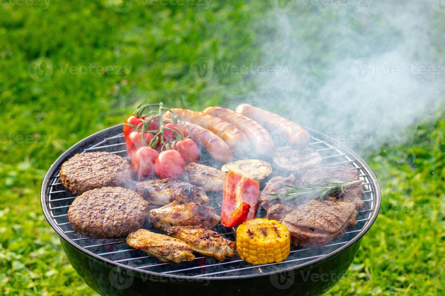 various meat and vegetables on grill photo