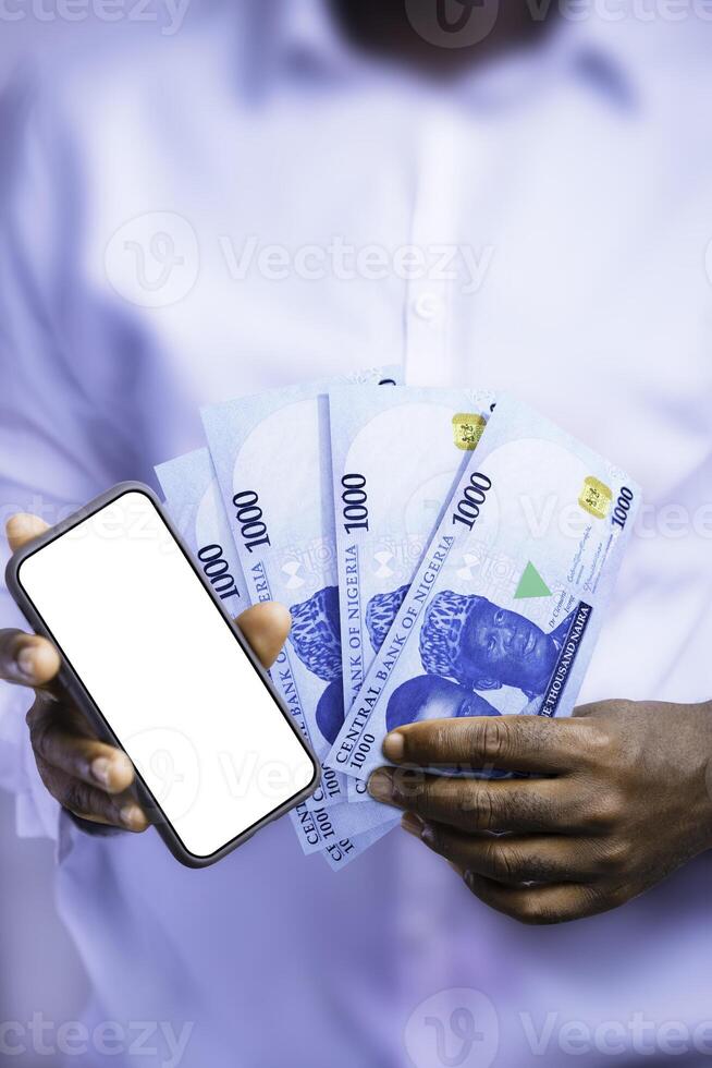 Black person holding Nigerian naira notes and showing phone with blank screen to the camera. Hand holding Nigerian currency notes, 3d rendered money photo