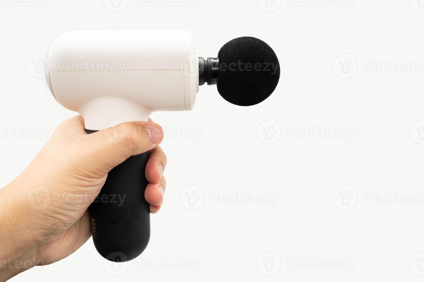 hand with a massage gun for therapeutic muscle relaxation. percussion massager isolated on white background. Copy space and clipping path. photo