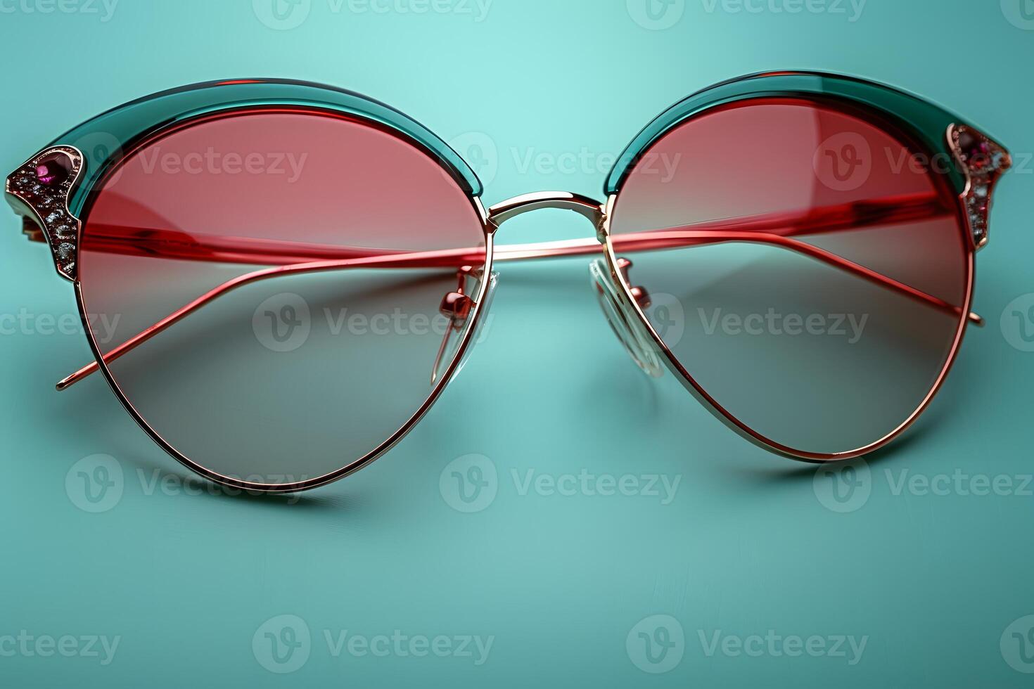 Stylish Retro Sunglasses with Red Tinted Lenses on Turquoise Background - Fashion Accessories for Summer and Style Statements photo