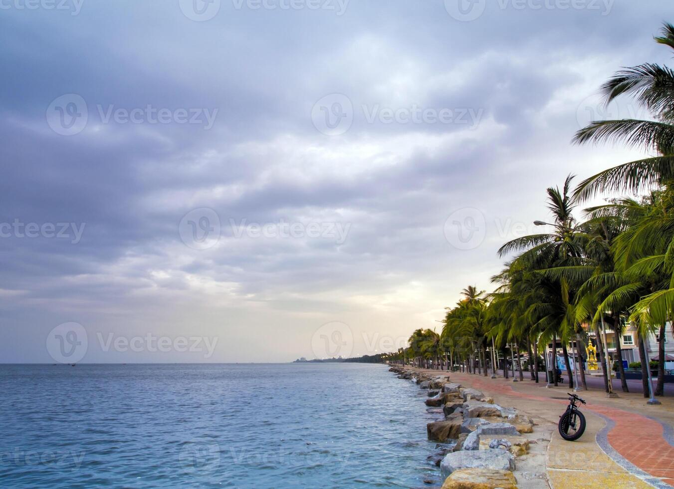 The sea is calm and the overcast sky with rain clouds in the morning of the coastal area photo