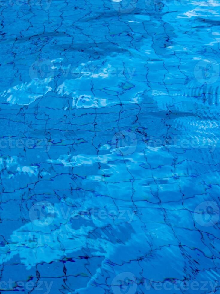 Reflection of sky on the moving water surface in the pool photo