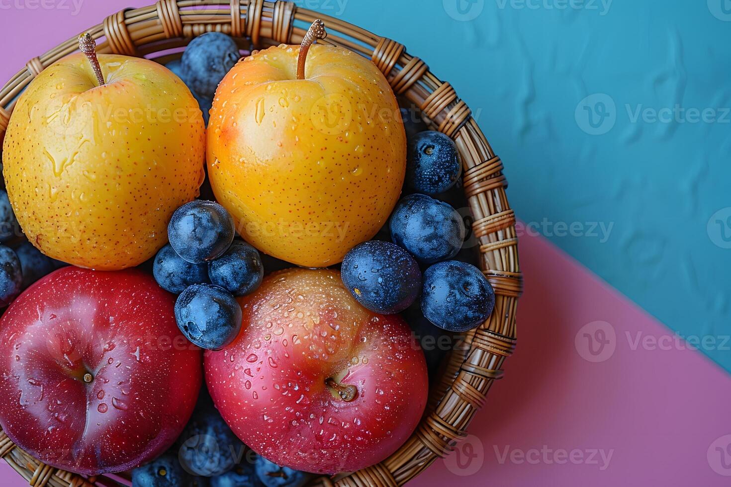 Fresh Mixed Fruit in Woven Basket - Apples, Pears, and Blueberries on Colorful Background photo