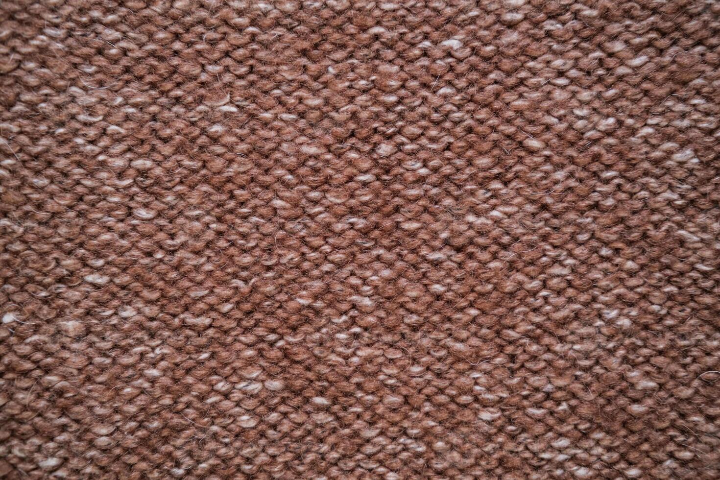 Texture of knitted woolen fabric in brown color photo