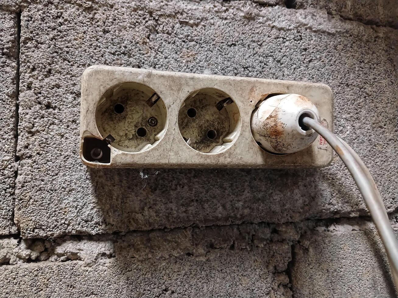 White electrical plug in wall electrical socket photo