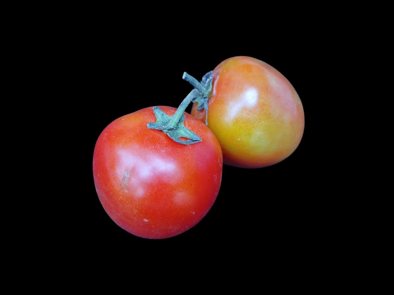 Set of red tomato vegetable fruits on black background good for food. photo