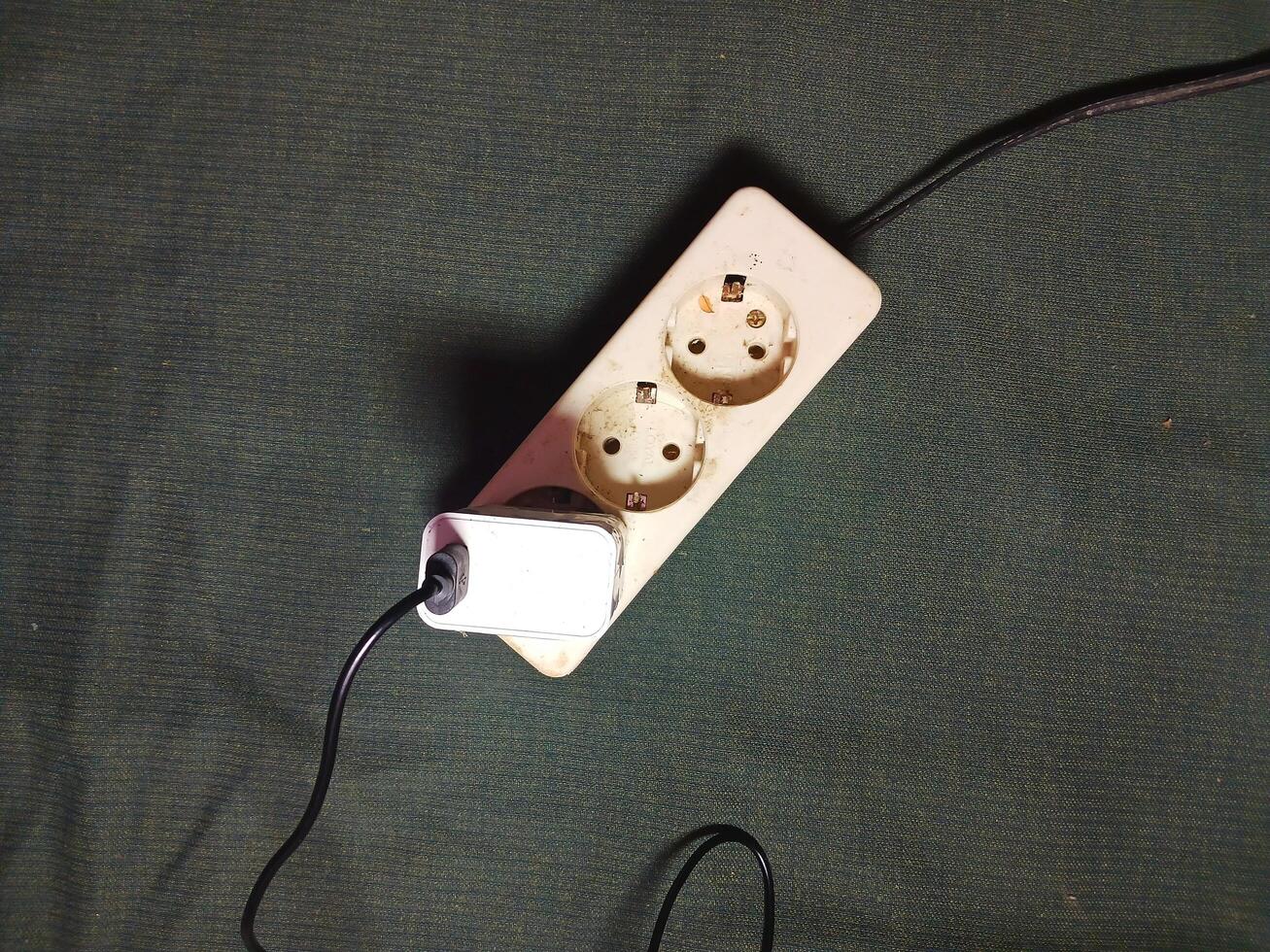 White electrical plug in wall socket. photo
