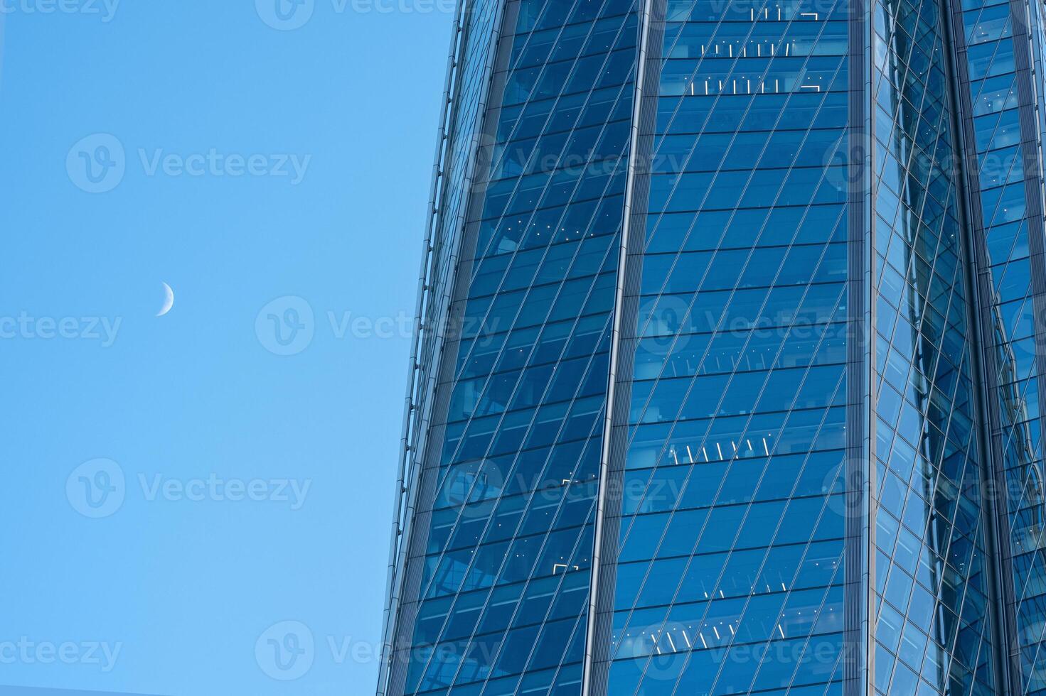 modern architecture, glass facade element of skyscraper against evening sky photo